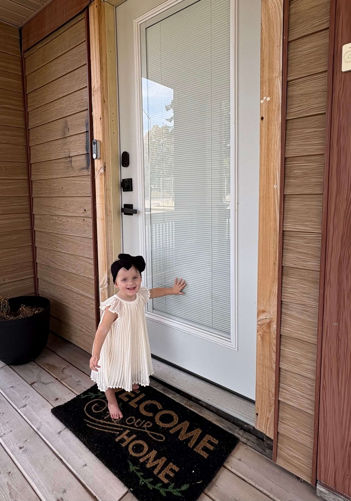 Little girl at a beautifully installed front door